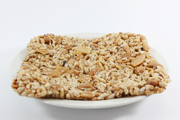 Krayasart, Thai sweet made of rice, nut, sesame-seeds and sugar on white background.