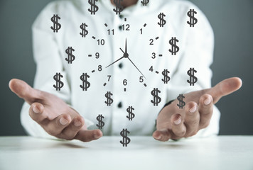 Businessman holding clock with dollar symbols. Time is money