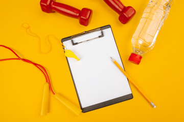Mockup clipboard with Gym equipment dumbbell on yellow background