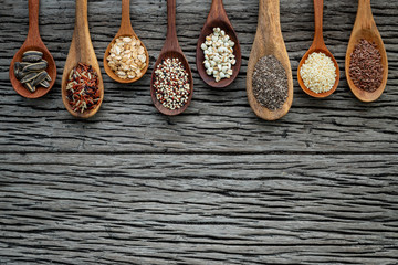 Different types of grains and cereals on shabby wooden background