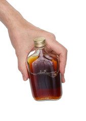 An elderly man holds in his hand the started flat bottle with cheap whiskey. Isolated