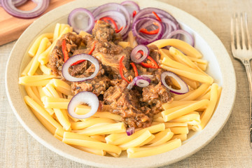 Pasta genovese - casarecce with genovese-style meat sauce, close-up