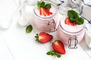 Jars with strawberry yogurt