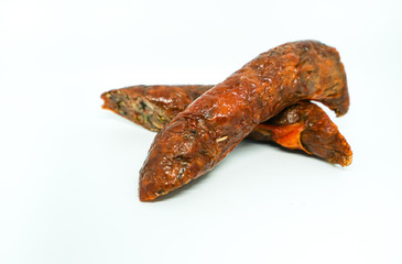 Sai ua or northern Thai sausage or Chiang Mai sausage is a grilled pork sausage from northern Thailand on white background.