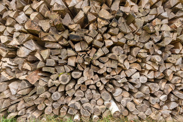 Old weathered firewood stacked format-filling as a background