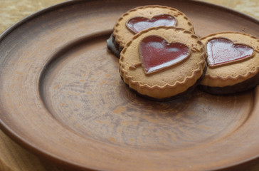 Sweet cookies in the form of heart, love on the plate. Background for greeting card Valentine's holiday