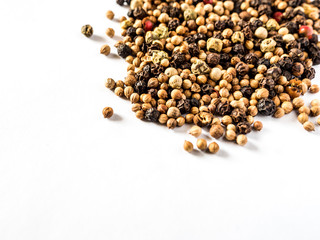 Black pepper on white background. Scattered pepper isolated on white background.