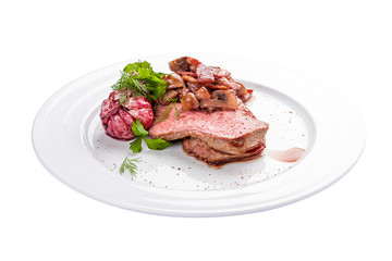 Roast beef with mushrooms and garlic. A traditional Spanish dish. On a white background