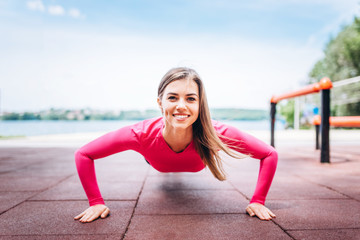 Pretty young sporty girl workout outdoor on the street.