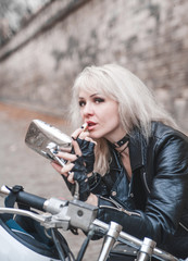 Fototapeta na wymiar Beautiful biker woman with motorcycle. 