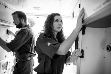 Paramedic team checking equipment in an ambulance - obrazy, fototapety, plakaty