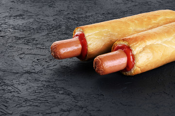 French hot dog on a dark background.