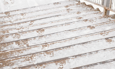 Closeup steps of the old stairs in the snow.
