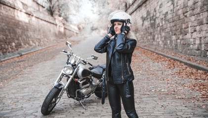 Fototapeta premium Beautiful biker woman with motorcycle. 