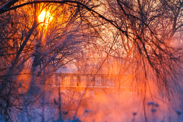 beautiful winter sunrise over a foggy river and bridge