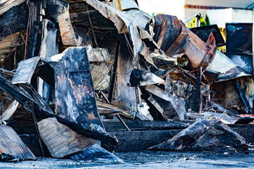 Burned damaged ruins of destroyed supermarket arson investigation insurance