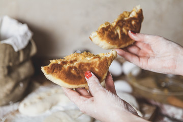 Two halves of donuts in female hands