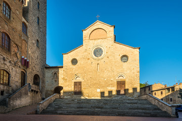 Fototapeta na wymiar View at the Cathedral of Santa Maria Assunta at the Place of Duomo in San Gimignano - Italy