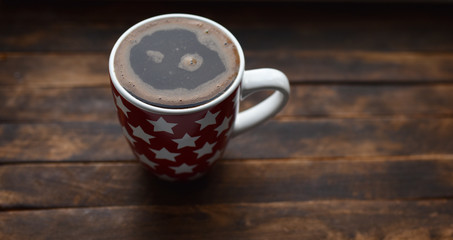 black coffee in white Cup on brown background
