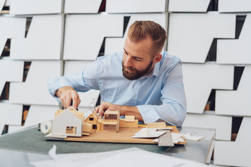 Male architect is working on 3D model