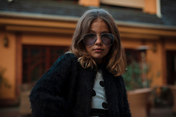 Girl in sunglasses. Posing on camera