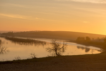 The sun at dawn by the Guadiana river