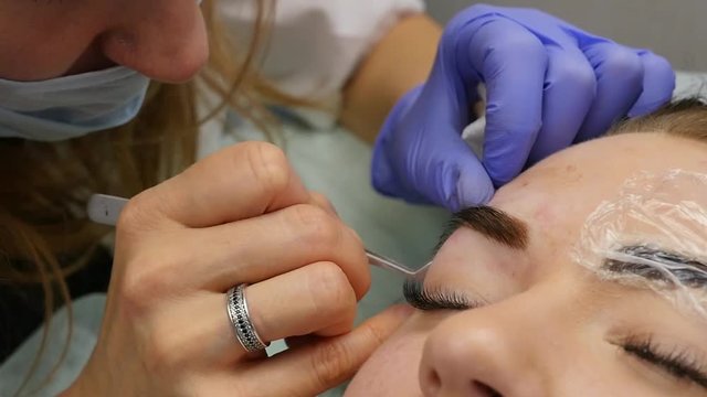 professional eyebrow permanent makeup. close-up brows tattoo. slow motion