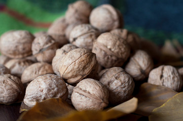 Walnuts with leaf on a wooden table.