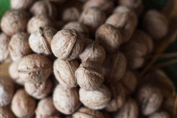 Walnuts with leaf on a wooden table.