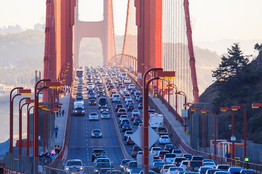 beautiful golden gate at sunset bridge in detail zoomed tele view to traffic jam