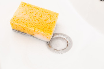 Sponge with foam inside sink.