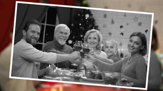 Cheerful family clinking wineglasses on Xmas eve, old family picture effect