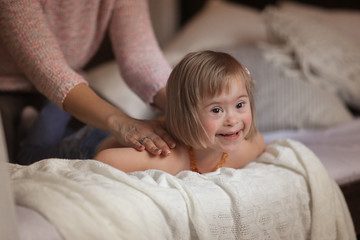 woman massage and gymnastics child Down syndrome