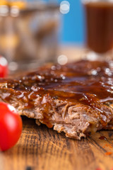 Delicious barbecued ribs seasoned with a spicy basting sauce and served with chopped fresh...