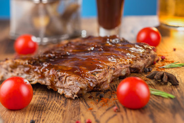 Delicious barbecued ribs seasoned with a spicy basting sauce and served with chopped fresh...