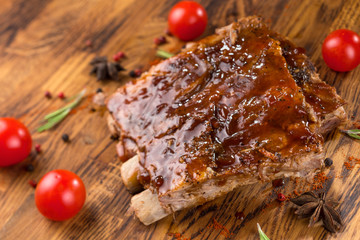Delicious barbecued ribs seasoned with a spicy basting sauce and served with chopped fresh...