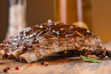 Delicious barbecued ribs seasoned with a spicy basting sauce and served with chopped fresh...