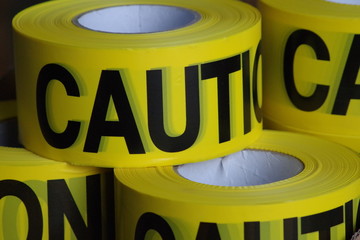Yellow caution ribbon used to inform people about danger or to close access to work site.