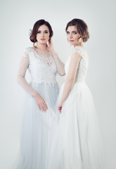 Fototapeta na wymiar Two glamorous bride portrait. Perfect women in white wedding dress