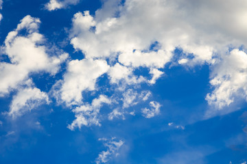 Blue sky with white cumulus clouds. Abstract natural background. Perfect summer day in the countryside.