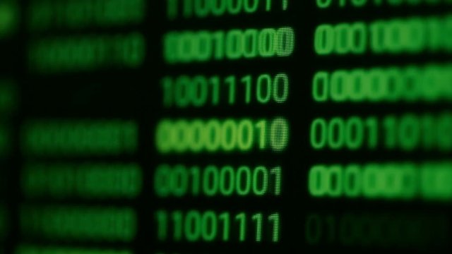 Close up footage of endless lines of computer green code, selective focus.