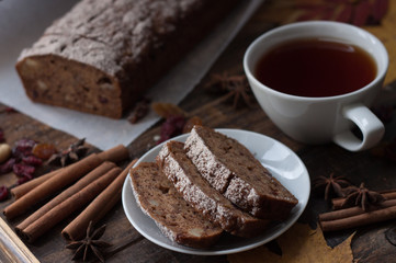 Homemade banana bread with anis star and cinnamon on a dark wooden background