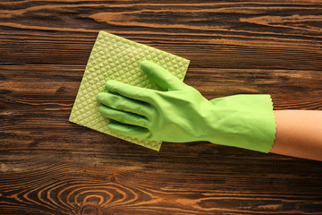 Woman cleaning wooden surface, top view