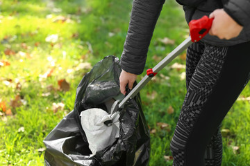 Woman gathering trash in park © Pixel-Shot