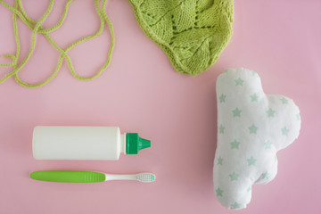 Cosmetics with toothbrush, knitted hat and toy on color background