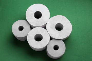 Rolls of toilet paper on color background