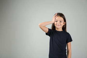 Emotional girl after making mistake on light background