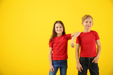 Obraz premium Cute children in t-shirts on color background