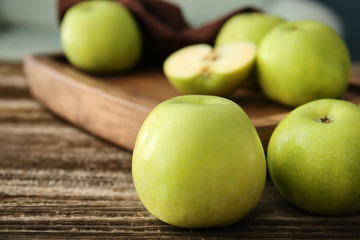 Ripe tasty apples on wooden table
