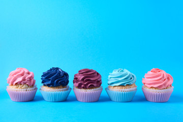 Tasty cupcakes on color background